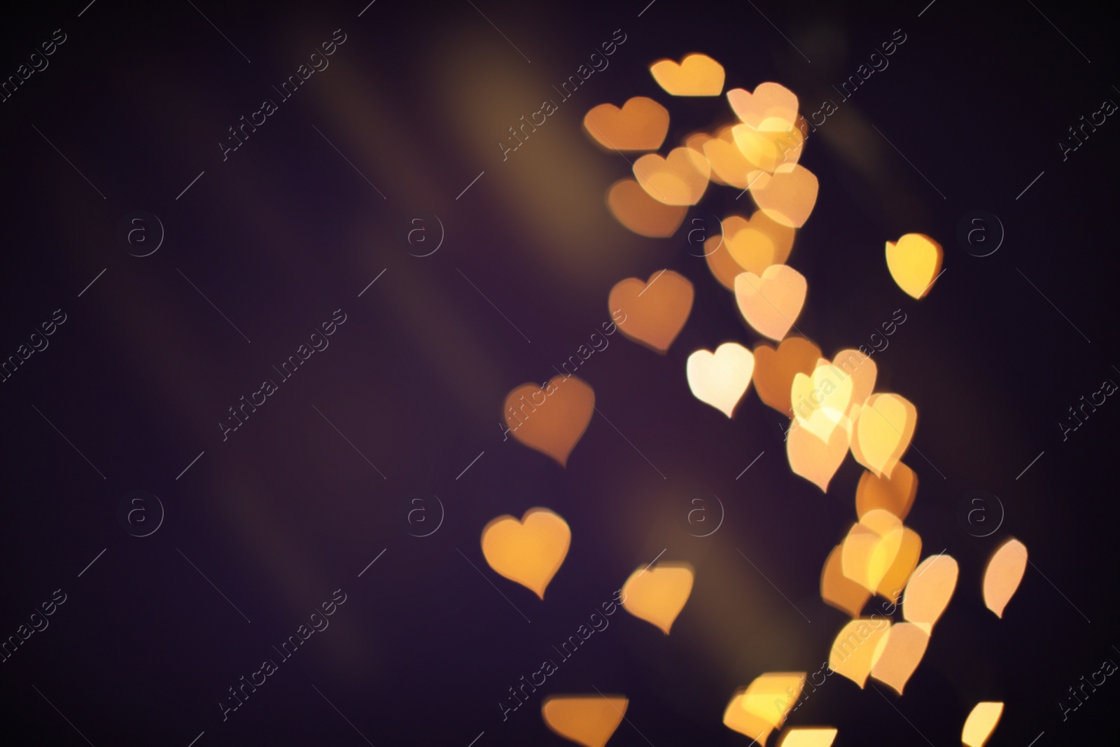 Photo of Blurred view of beautiful lights on purple background. Bokeh effect