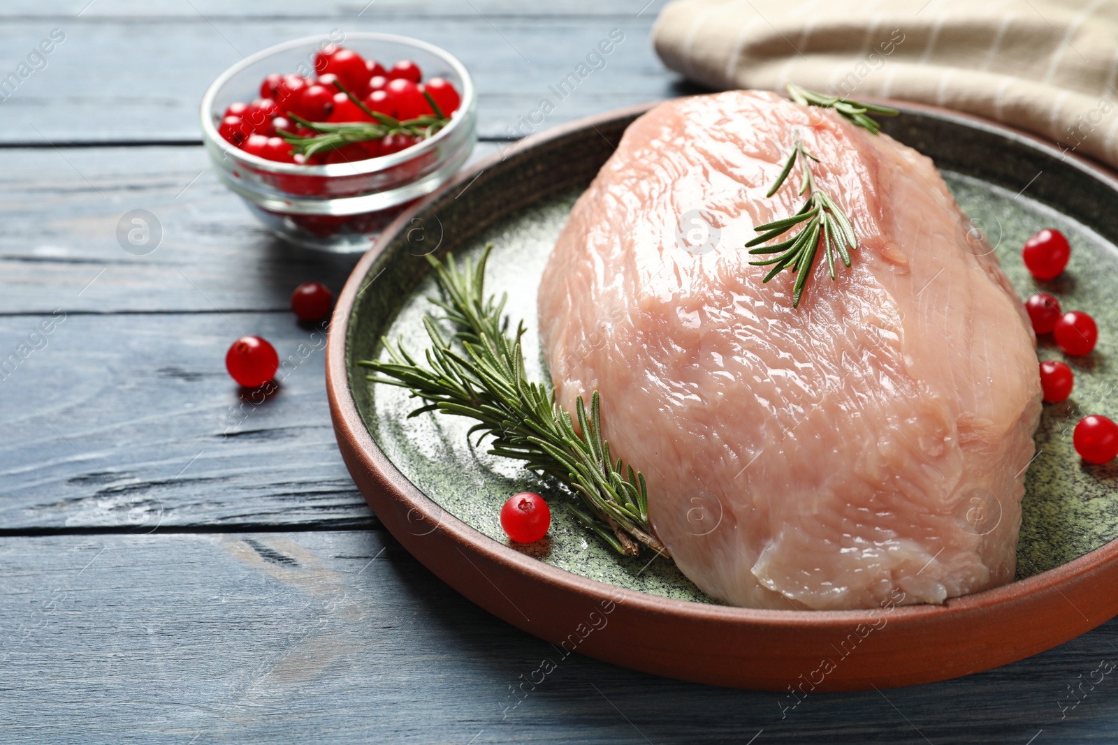 Photo of Plate with raw turkey fillet and ingredients on wooden background
