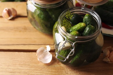 Photo of Jar with cucumbers, garlic and dill on wooden table, space for text. Pickling recipe