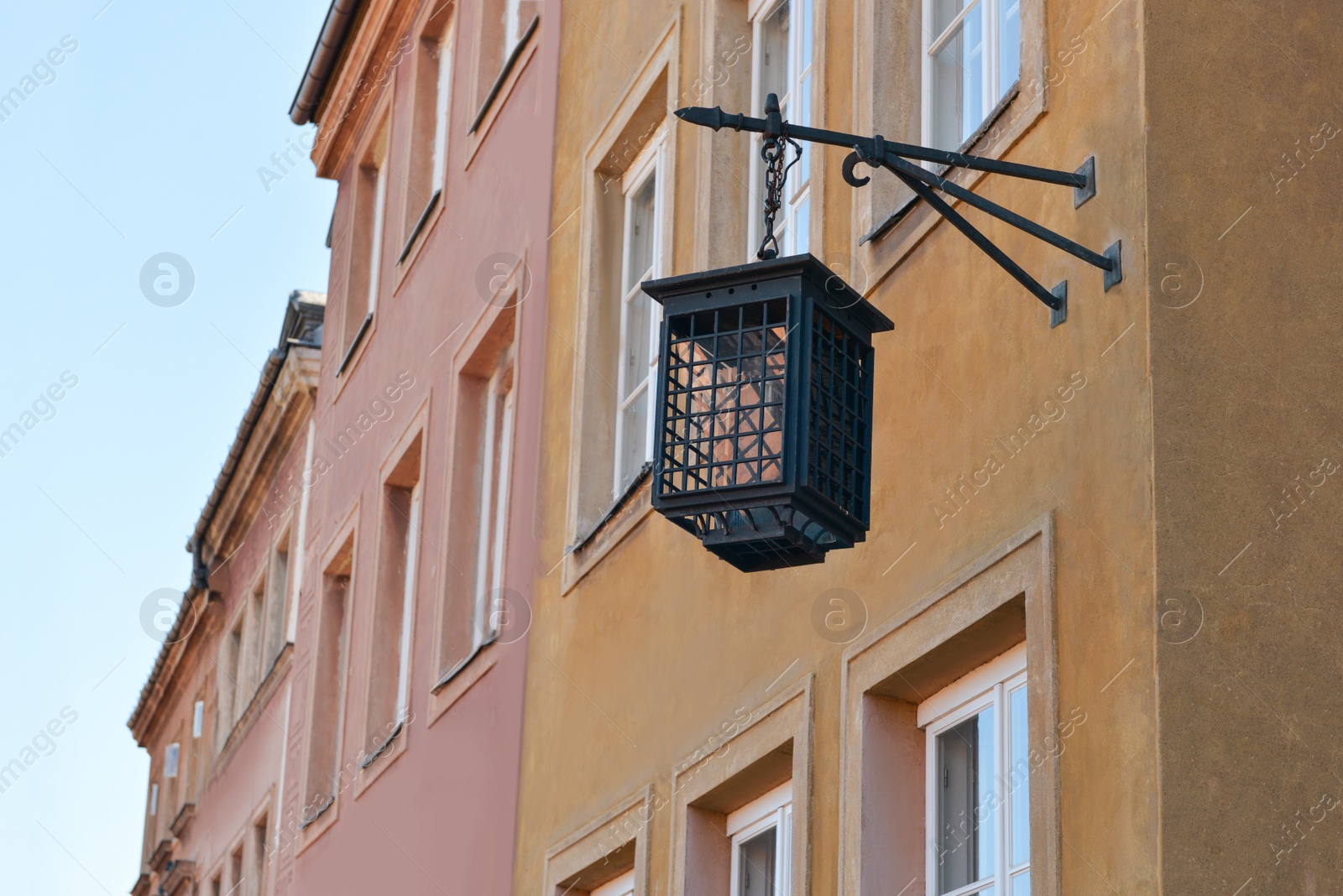 Photo of Beautiful vintage street lamp hanging on wall of building