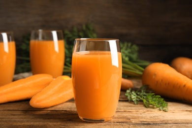 Freshly made carrot juice on wooden table