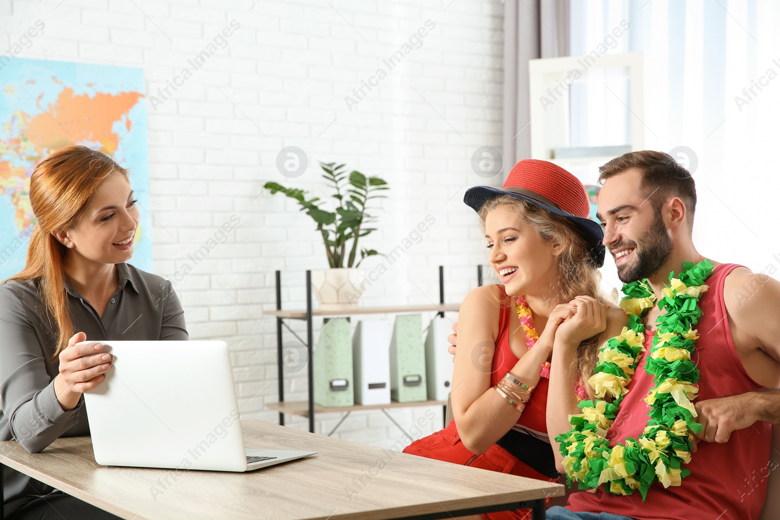 Photo of Beautiful young couple visiting travel agency office