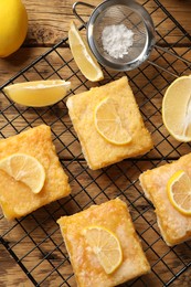 Photo of Tasty lemon bars on wooden table, top view