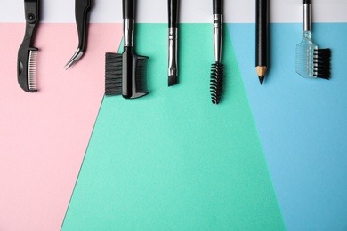 Photo of Set of professional eyebrow tools on color background, flat lay. Space for text