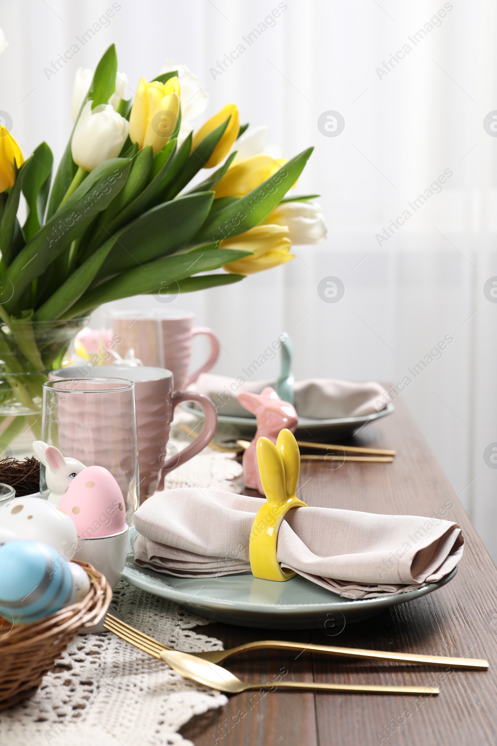 Photo of Festive table setting with beautiful flowers. Easter celebration