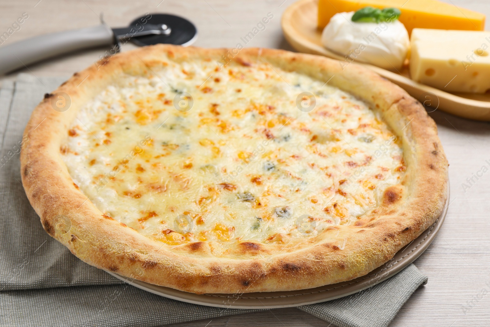 Photo of Delicious cheese pizza on wooden table, closeup