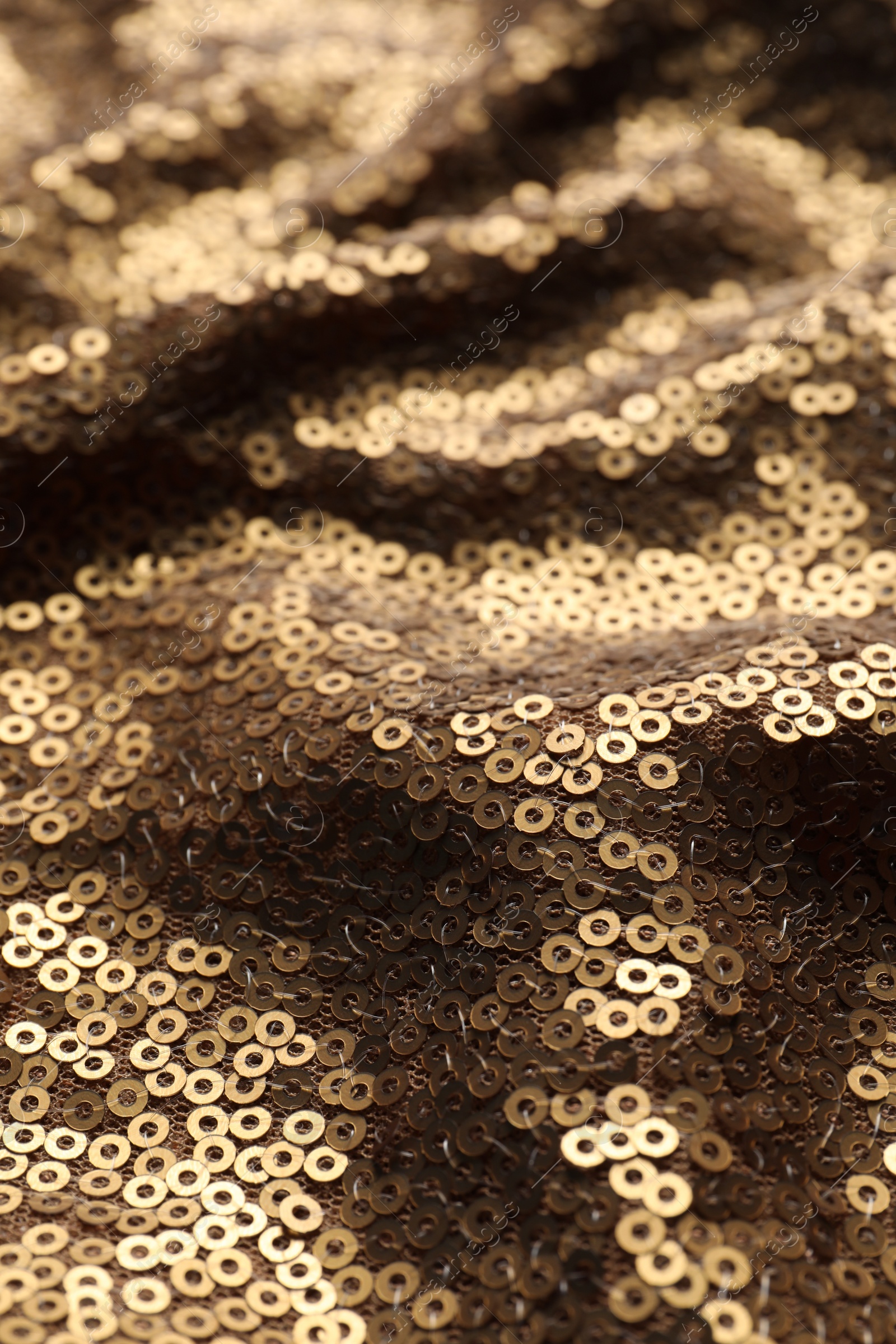 Photo of Beautiful golden sequin fabric as background, closeup