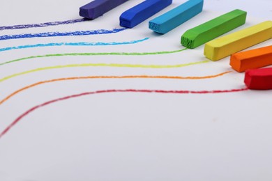 Photo of Colorful pastel chalks and lines on white background. Drawing materials