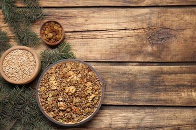 Photo of Traditional Christmas slavic dish kutia served on wooden table, flat lay. Space for text