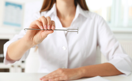 Photo of Speech therapist with logopedic probe in clinic, closeup