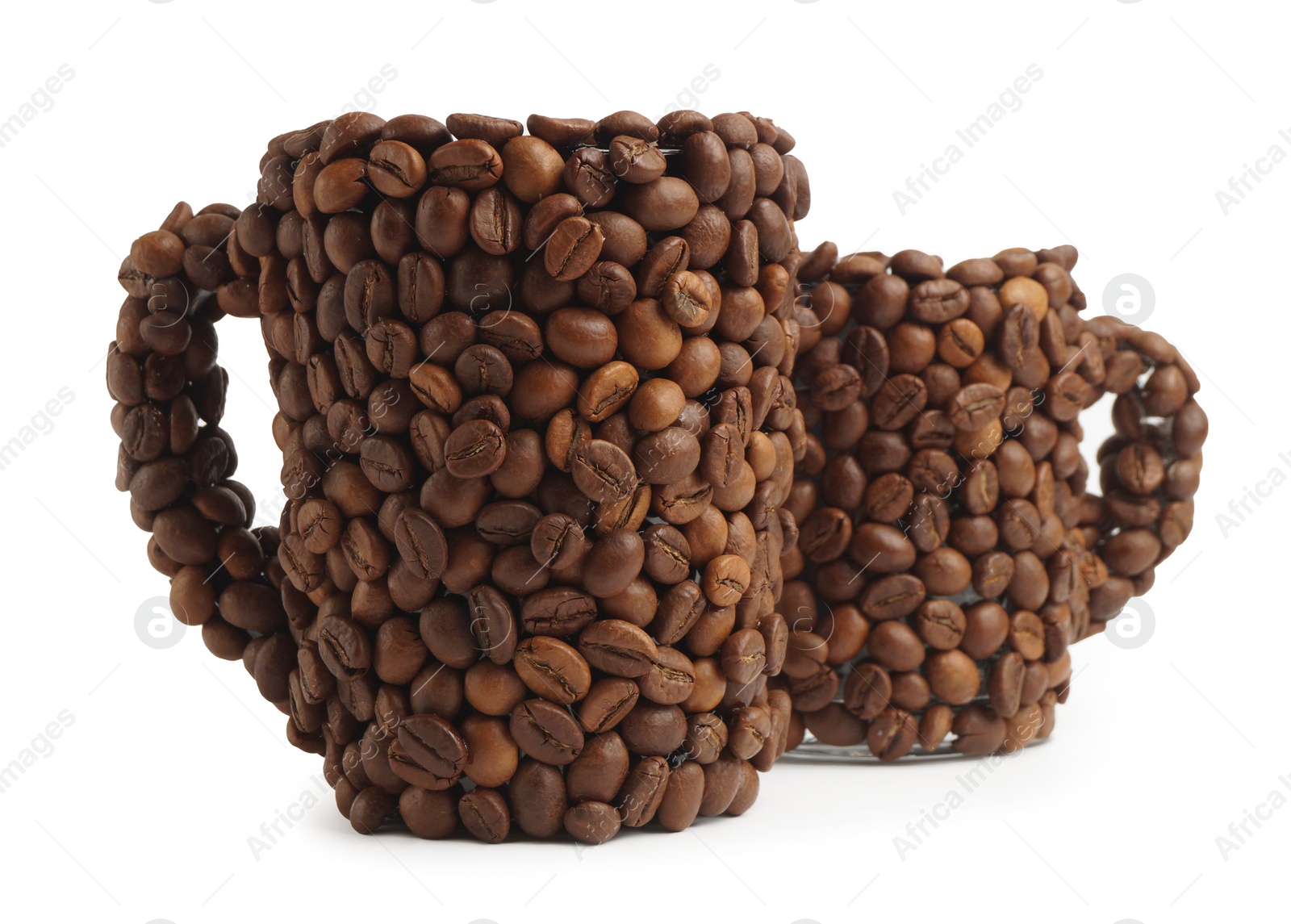 Photo of Cups of drink, composition made with coffee beans isolated on white