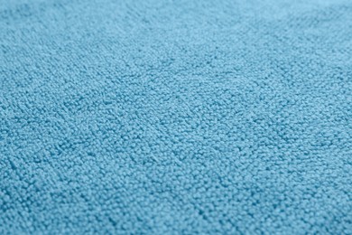 Photo of Dry soft blue towel as background, closeup