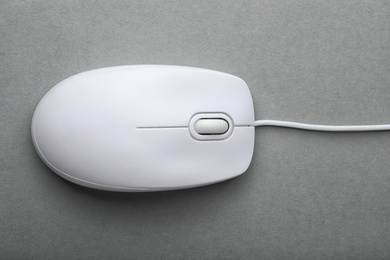 Modern wired computer mouse on grey background, top view