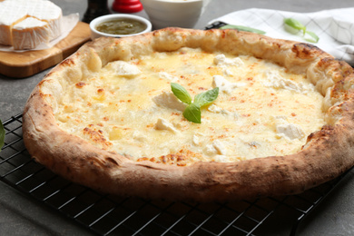 Photo of Delicious hot cheese pizza on table, closeup