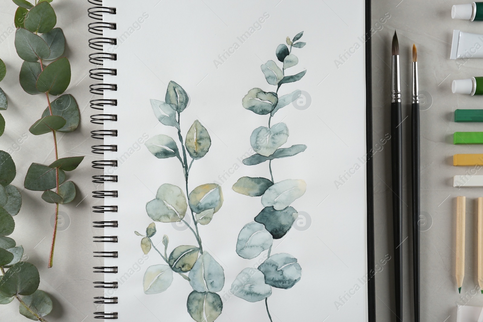 Photo of Flat lay composition with beautiful drawing of eucalyptus branches on white table