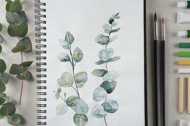 Photo of Flat lay composition with beautiful drawing of eucalyptus branches on white table