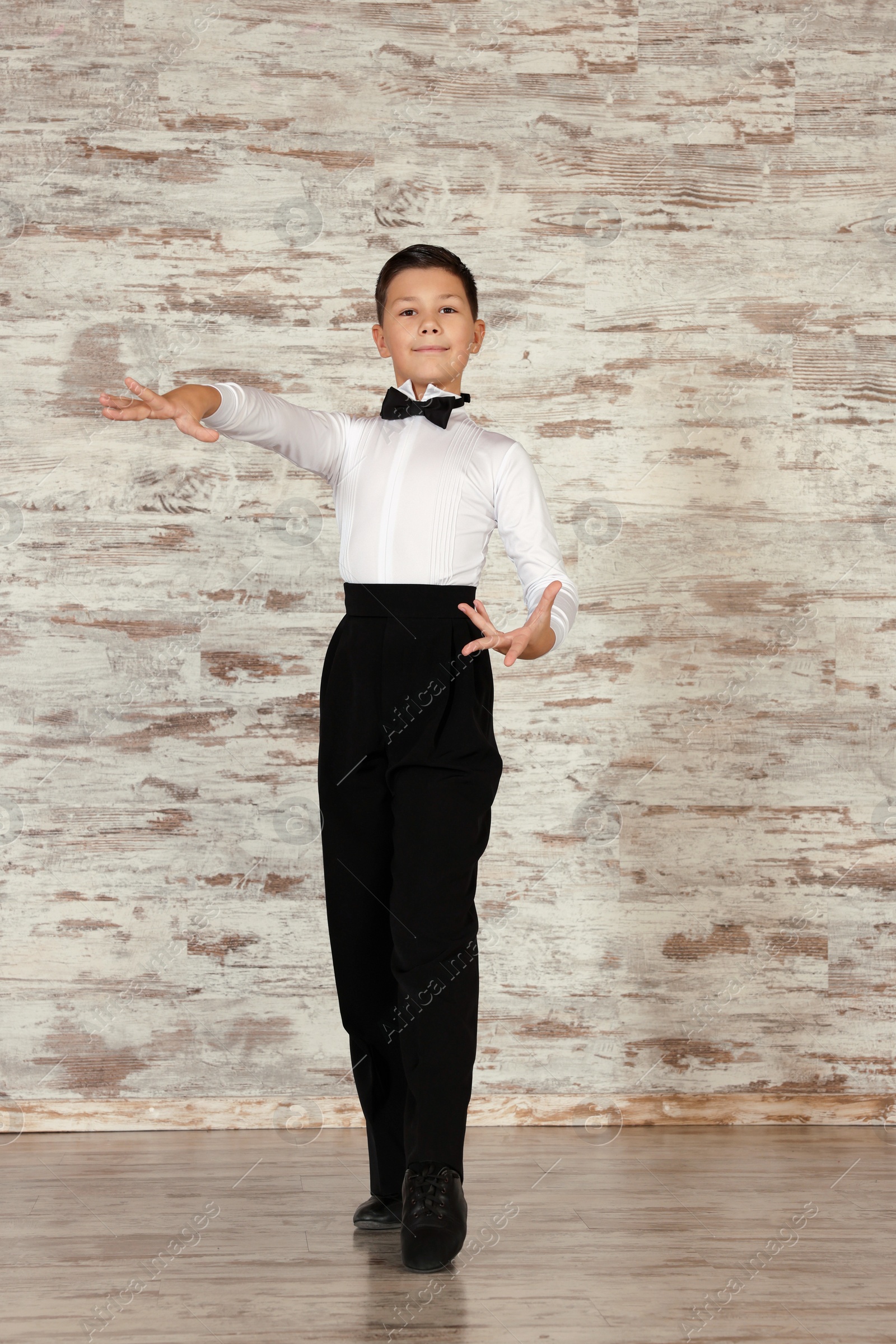 Photo of Beautifully dressed little boy dancing in studio