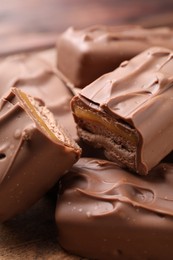 Tasty chocolate bars with nougat as background, closeup