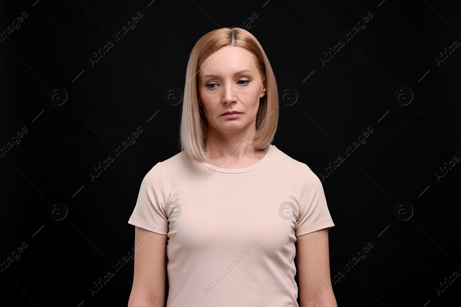 Photo of Portrait of sad woman on black background