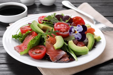 Tasty vegetable salad with soy sauce served on wooden table, closeup