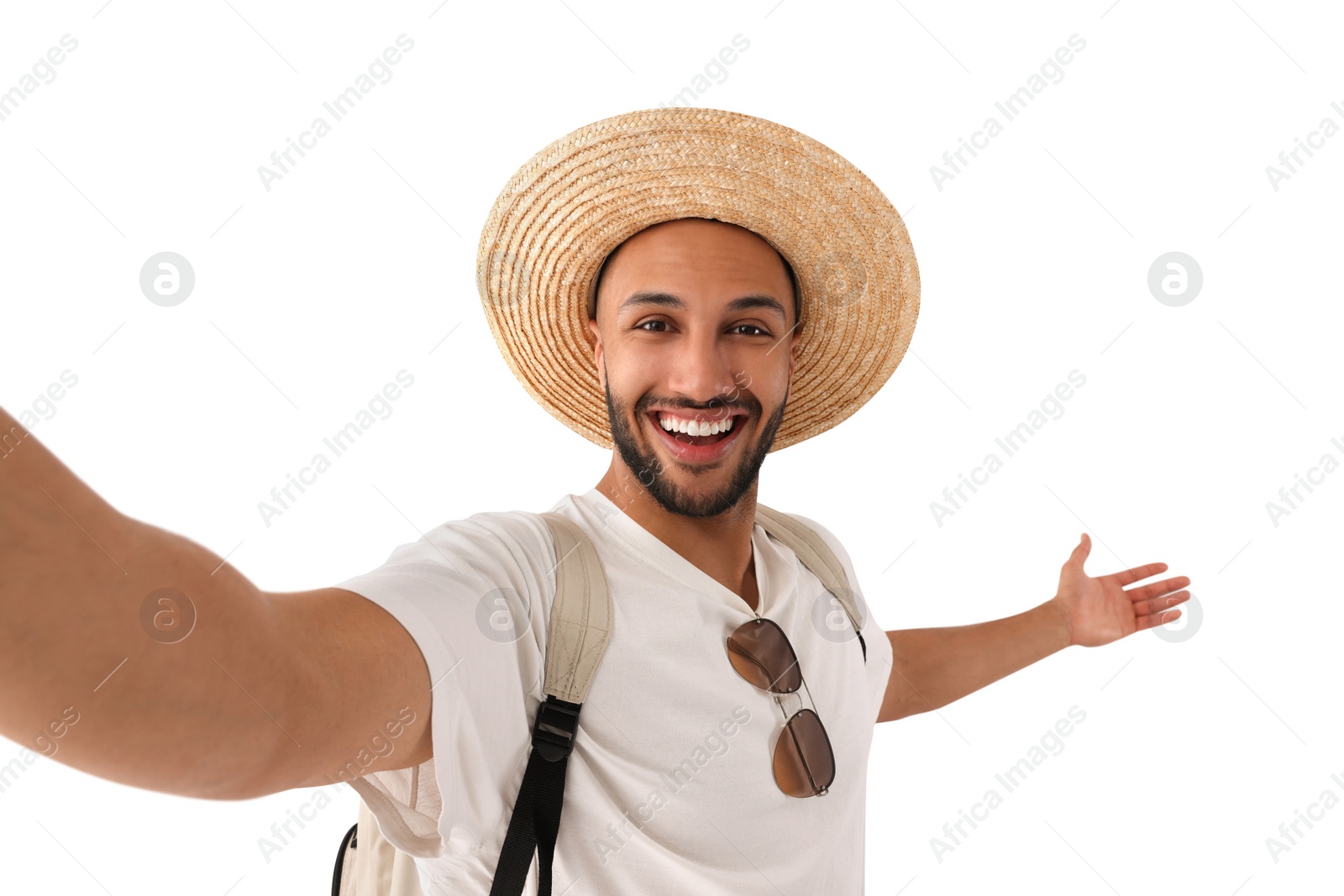 Photo of Smiling young man in straw hat taking selfie on white background