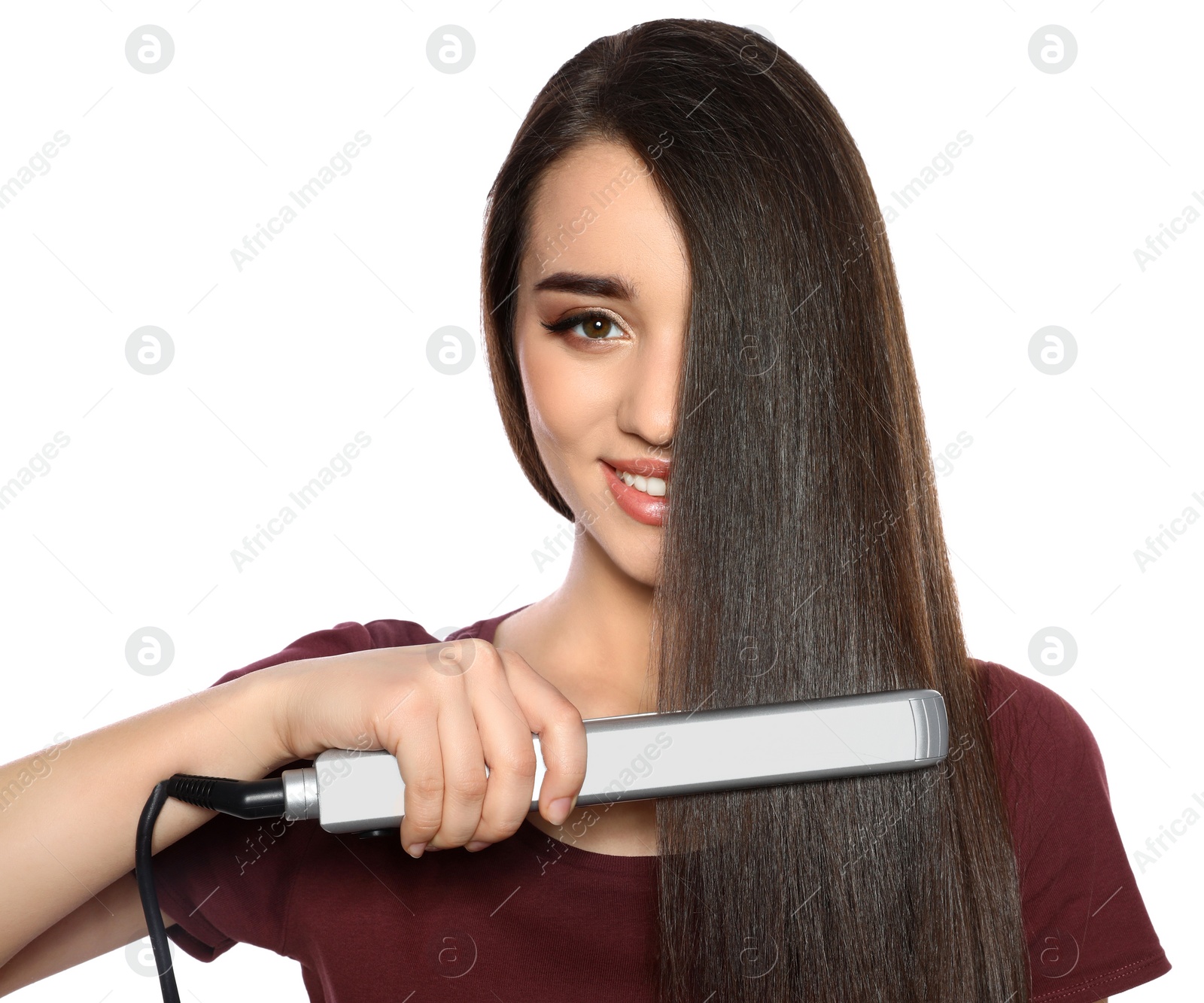 Photo of Happy woman using hair iron on white background