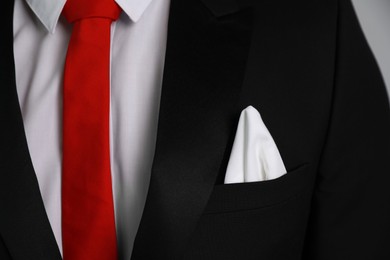 Man with handkerchief in suit pocket, closeup view