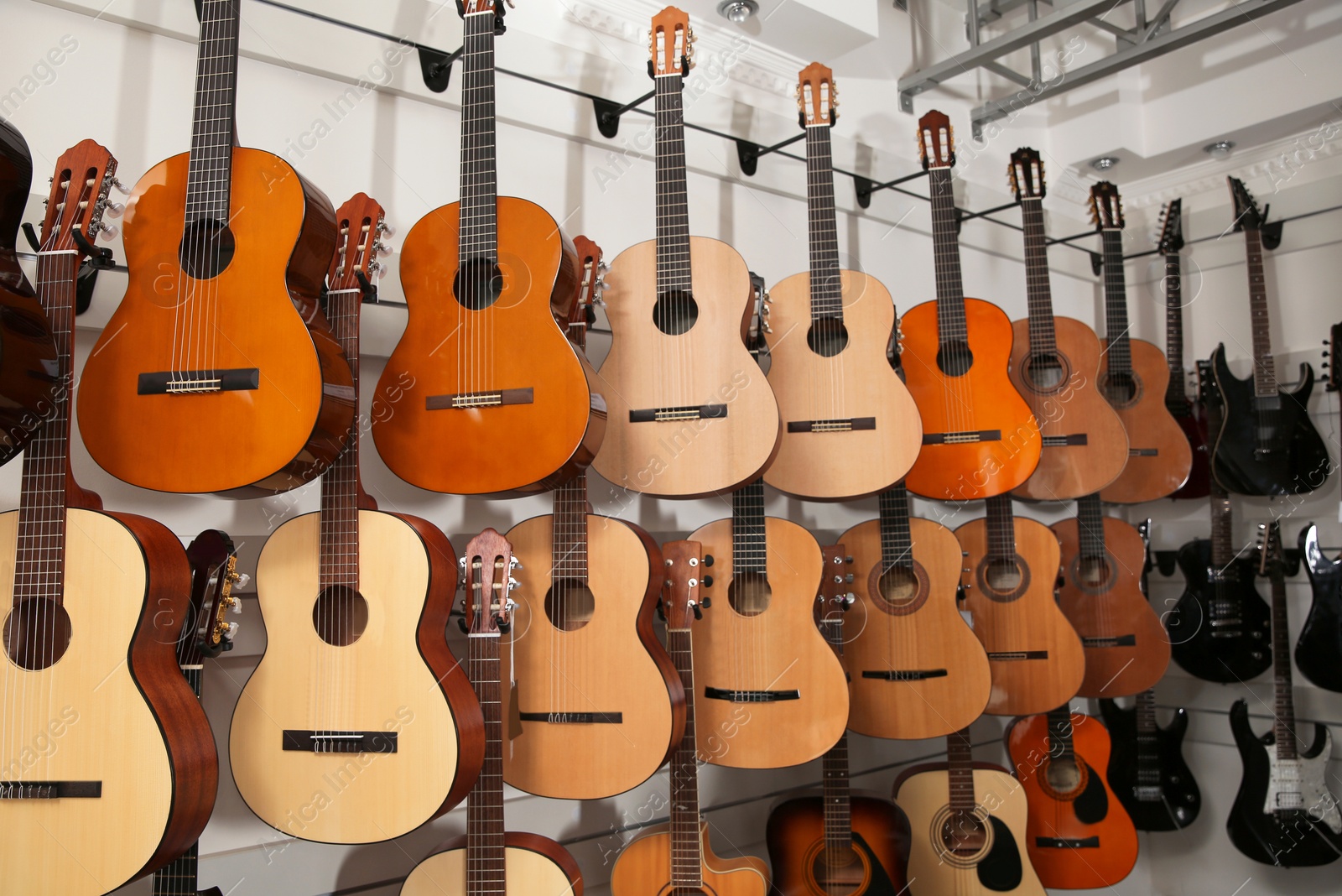 Photo of Rows of different guitars in music store