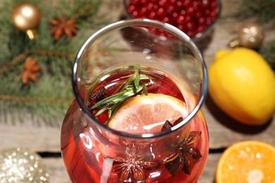 Glass bottle of aromatic punch drink on table, closeup