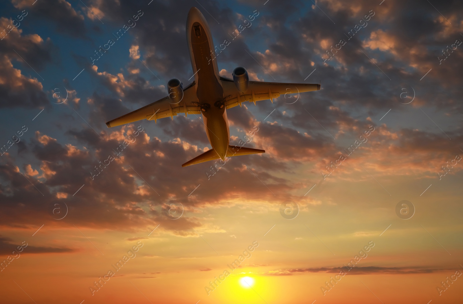 Image of Plane in sky during sunset, low angle view