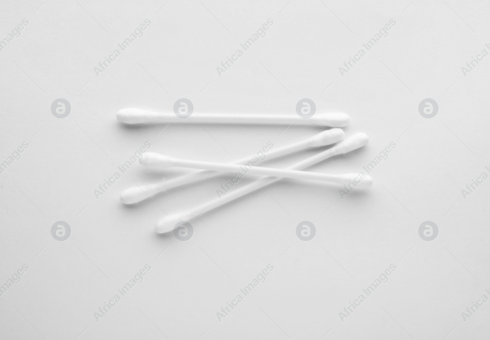 Photo of Clean cotton buds isolated on white, top view