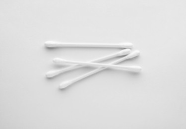 Photo of Clean cotton buds isolated on white, top view