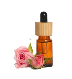 Photo of Bottle of essential rose oil and flowers against white background