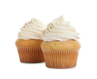 Delicious cupcakes decorated with cream on white background