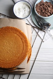 Ingredients for delicious homemade layer cake preparing on white wooden table, flat lay