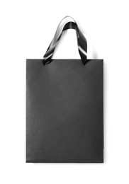 One black paper shopping bag isolated on white, top view