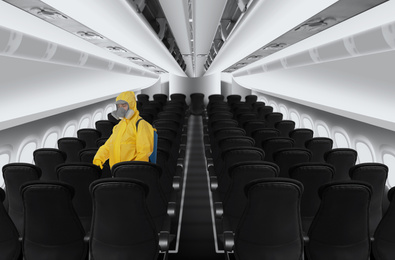 Image of Man wearing protective suit cleaning cabin in airplane to prevent spreading of Coronavirus