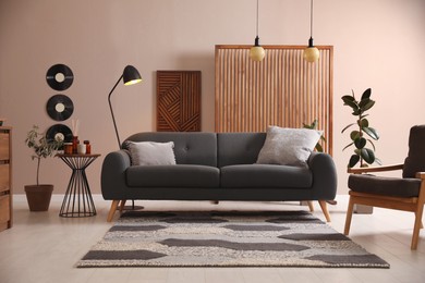 Photo of Stylish living room interior with comfortable dark sofa