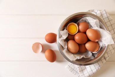 Fresh raw chicken eggs on white wooden table, flat lay. Space for text