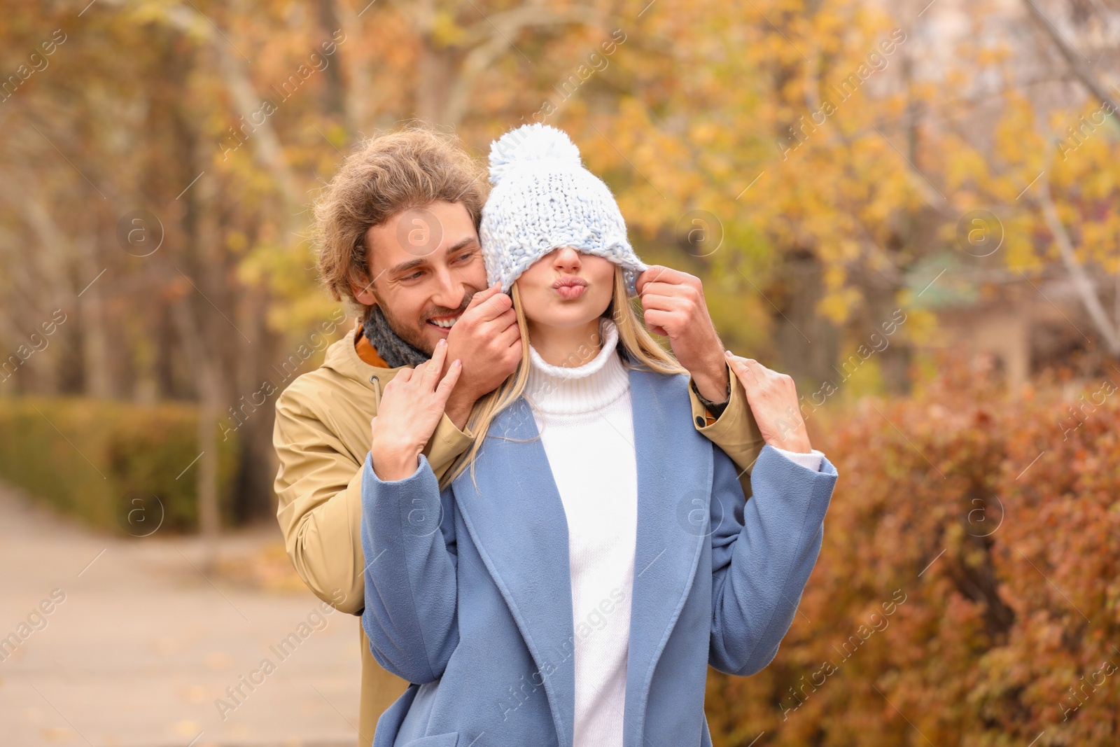 Photo of Young romantic couple having fun in park on autumn day