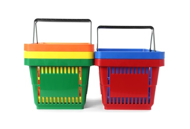 Colorful plastic shopping baskets on white background