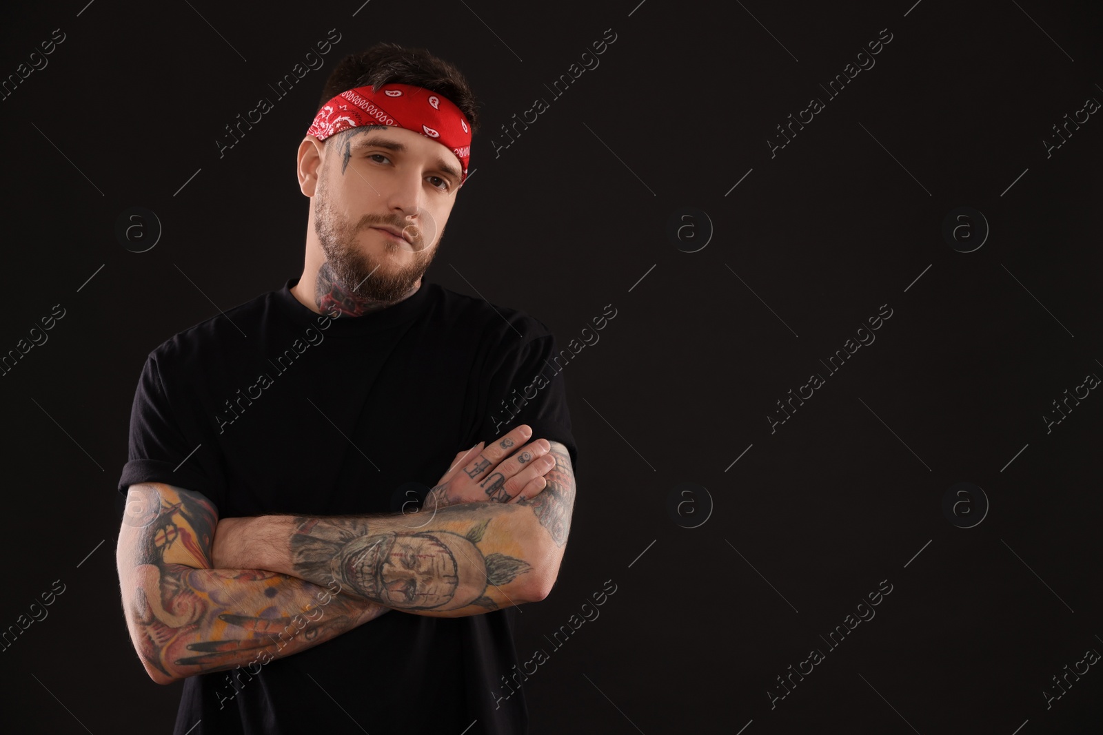 Photo of Portrait of handsome hipster man on black background. Space for text