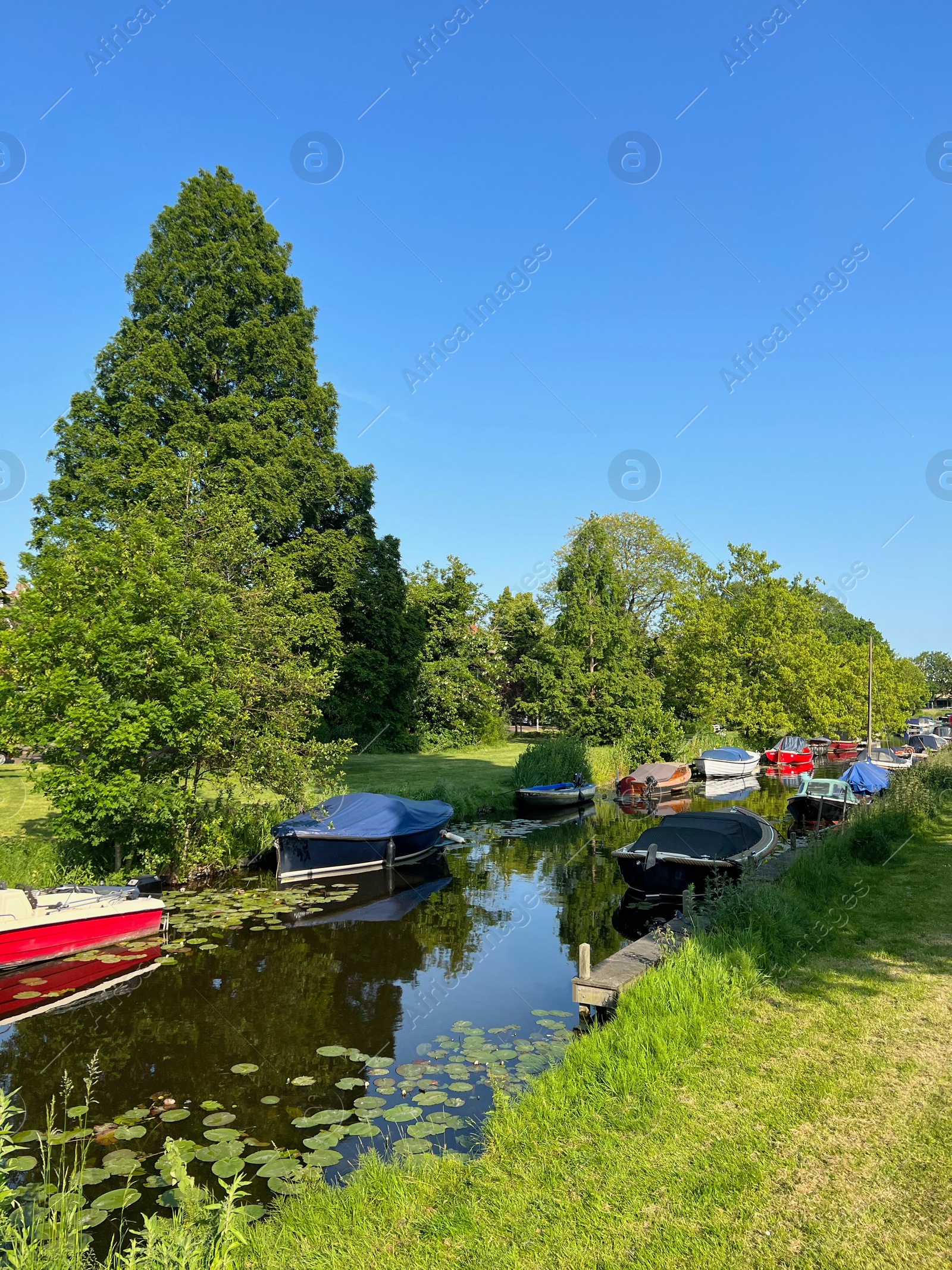 Photo of Canal with moored boats outdoors on sunny day