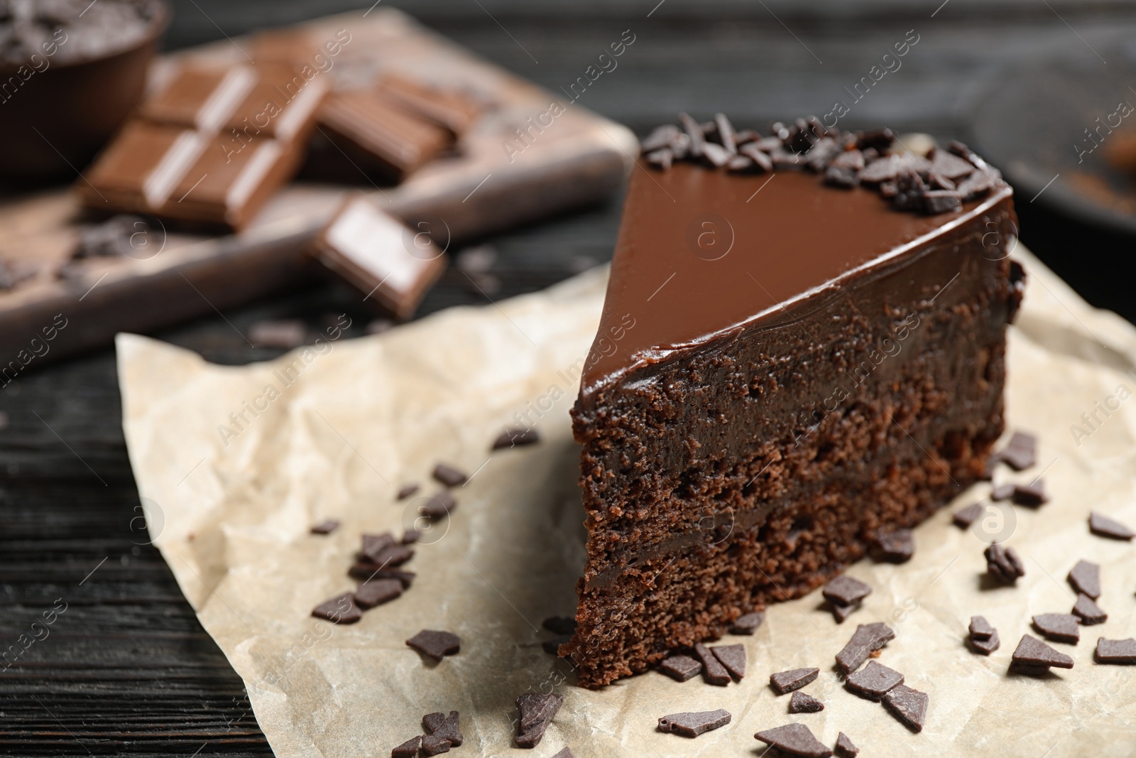 Photo of Delicious fresh chocolate cake on wooden table, closeup