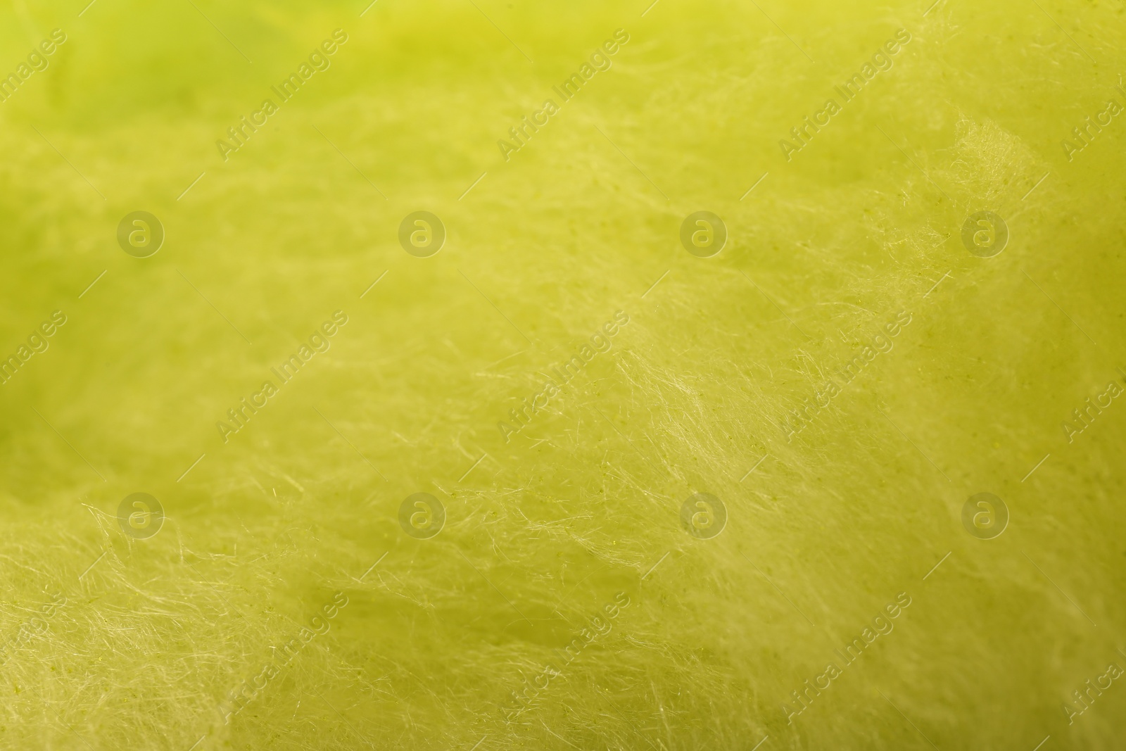 Photo of Sweet yellow cotton candy as background, closeup