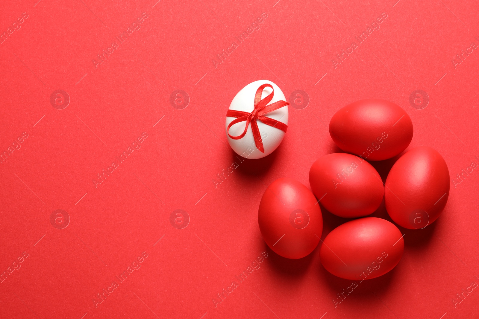 Photo of Flat lay composition of dyed Easter eggs on color background, space for text