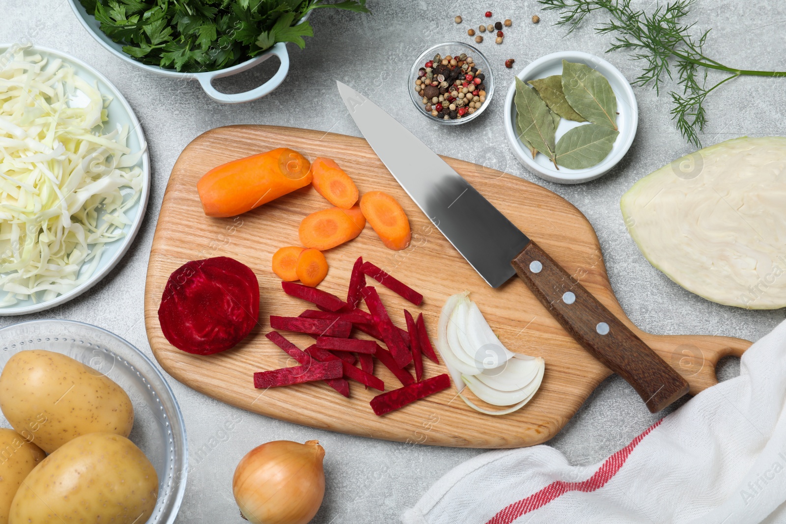 Photo of Fresh ingredients for borscht on light grey table, flat lay