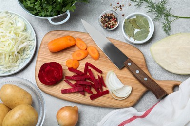 Fresh ingredients for borscht on light grey table, flat lay