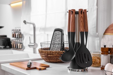 Photo of Set of different utensils on countertop in kitchen