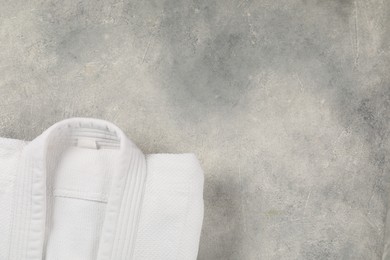 Photo of White kimono on gray background, top view. Space for text